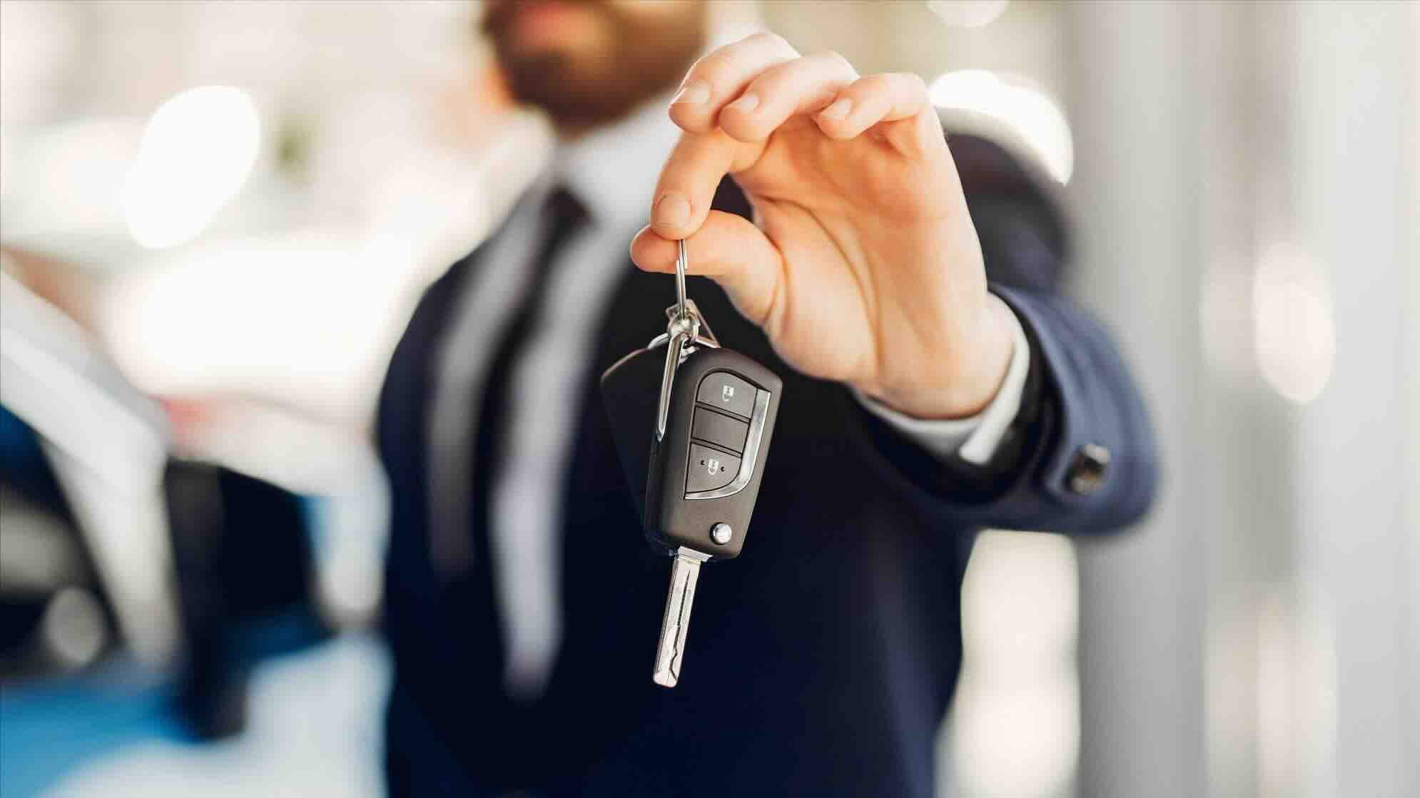 Car keys being handed over to a buyer, representing the final step when you sell a car in Dubai.